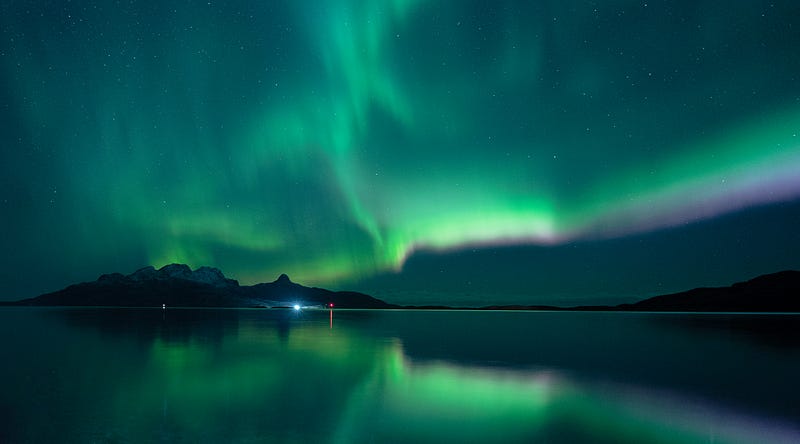 A serene winter landscape illuminated by the Northern Lights