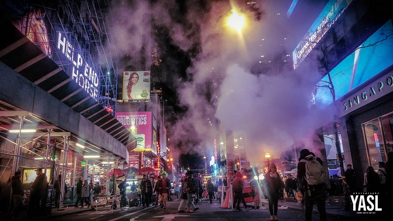 A quiet side street in Times Square with steam rising