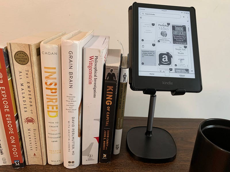 A well-organized study area with a Kindle prominently displayed