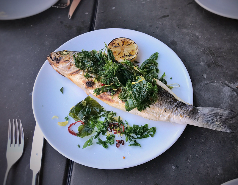 A delicious plate of grilled branzino with herbs